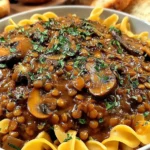 Lentil Mushroom Stroganoff served over egg noodles with fresh herbs