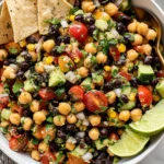 Southwest Chickpea Black Bean Salad served with tortilla chips and fresh lime wedges