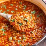 Vegan Lentil Chili Recipe served warm with a spoon, showing rich texture and bold spices