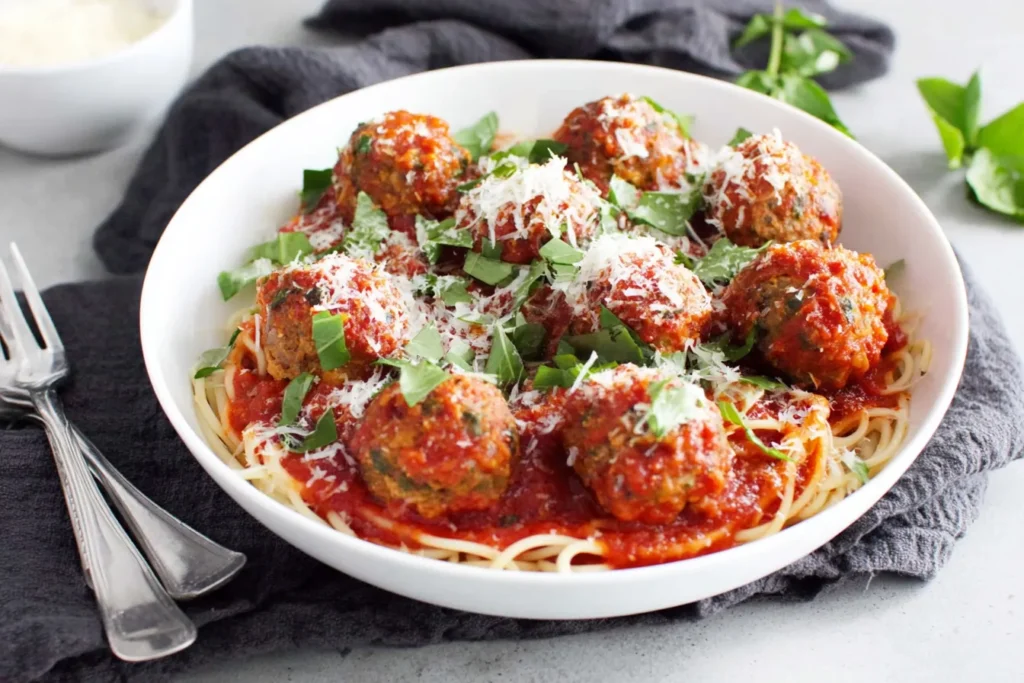 Vegetarian Lentil Meatballs baked in rich tomato sauce with fresh basil