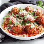 Vegetarian Lentil Meatballs baked in rich tomato sauce with fresh basil
