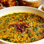 Dal Palak (Spinach Dal) served in a bowl with vibrant lentils, spinach, and spiced chili oil garnish.