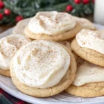 Soft Eggnog Cookies topped with creamy eggnog frosting and a light dusting of nutmeg, served on a festive holiday plate.