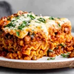 Lentil Lasagna slice layered with hearty lentils, tomato sauce, and creamy vegan cheese