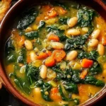 Spinach Lentil and Butter Bean Soup Recipe in a rustic bowl with tender lentils, creamy butter beans, fresh spinach, and vegetables served with toasted bread.