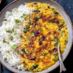 Caramelized Onion Dal served with fluffy white rice, topped with caramelized onions, herbs, and a rich golden lentil curry.