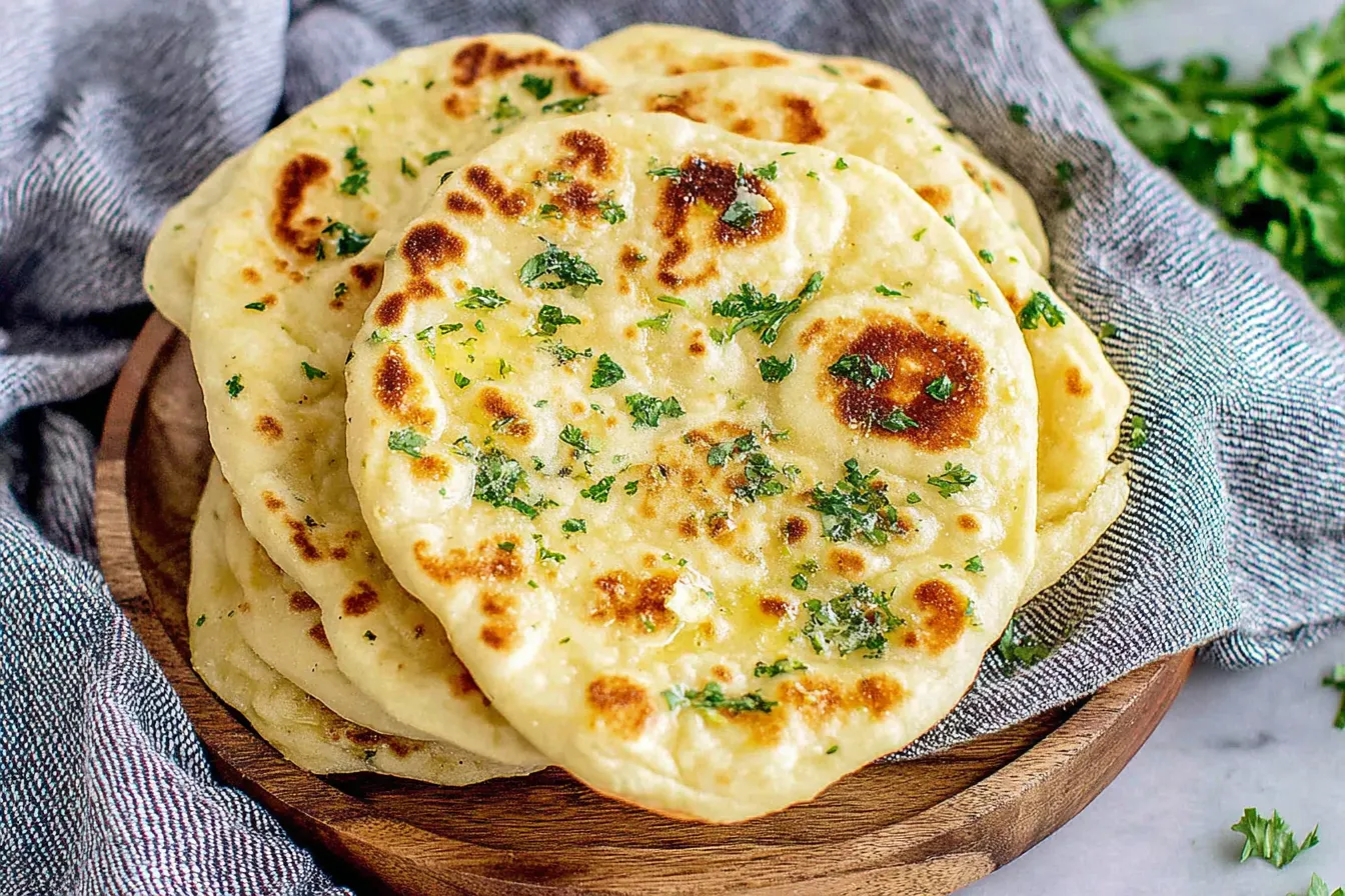 Easy Flatbread Recipe topped with garlic butter and parsley on rustic wooden plate