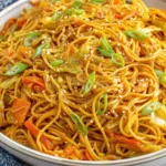 Easy One-Pot Teriyaki Noodles Recipe plated with cabbage, carrots, sesame seeds, and green onions