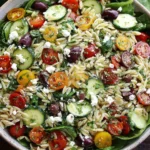 Fresh Mediterranean Orzo Salad with cherry tomatoes, cucumbers, olives, feta, and spinach