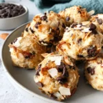 Golden Almond Joy Protein Balls with toasted coconut chocolate chips and almonds