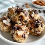 Almond Joy Protein Balls with chocolate chips coconut and almonds on a plate