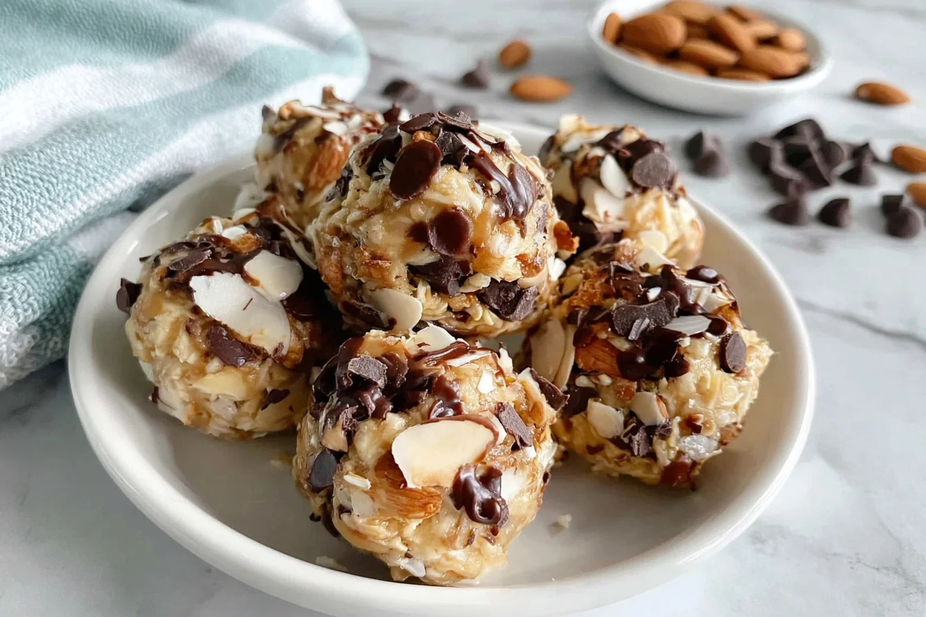Almond Joy Protein Balls with chocolate chips coconut and almonds on a plate