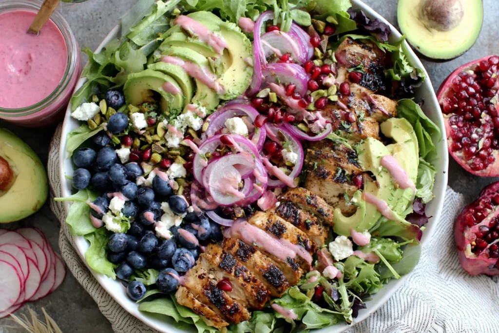 Blueberry and Pistachio Spring Salad with grilled chicken, avocado, and pomegranate dressing