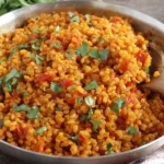 Bulgur Tomato Pilaf in a pan with fresh parsley and tomatoes
