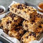 Easy No Bake Granola Bars on tray with chocolate chips and honey