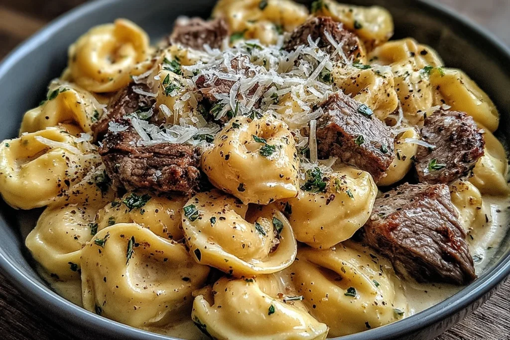 Garlic Steak Tortellini topped with parmesan cheese and herbs in creamy sauce