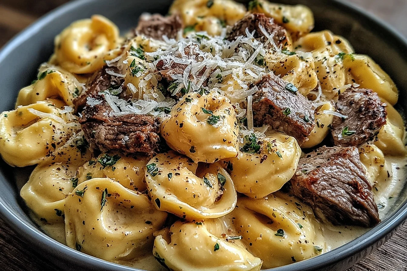 Garlic Steak Tortellini topped with parmesan cheese and herbs in creamy sauce