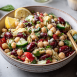 Healthy & High Protein Three Bean Salad Recipe served in a bowl with chickpeas, kidney beans, cucumber, artichokes and parmesan
