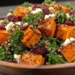Roasted Sweet Potato and Baby Kale Salad with quinoa, cranberries, feta, and walnuts in a healthy grain bowl