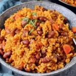 Spanish Rice And Beans served in a bowl with fluffy rice, kidney beans, tomatoes, and fresh herbs – hearty one-pot comfort meal
