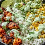 30-Minute Street Corn Chicken Rice Bowl with grilled chicken, charred corn, rice, and creamy cilantro lime sauce