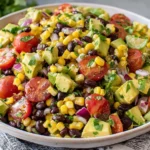 Close-up of Black Bean Salad with Corn & Avocado mixed with red onion and lime dressing