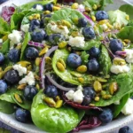 Blueberry Pistachio Spring Salad with fresh greens, feta cheese, and balsamic dressing