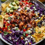 Chipotle Chicken Chopped Salad topped with tortilla chips, avocado, black beans, and chipotle vinaigrette