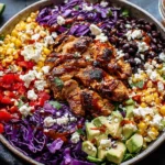 Chipotle Chicken Chopped Salad with grilled chicken, black beans, corn, avocado, and cotija cheese in a colorful bowl