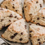 Chocolate Chip Sourdough Scones arranged on a plate with flaky layers and chocolate chips