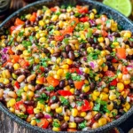 Cowboy Caviar colorful bean corn dip with fresh vegetables and lime