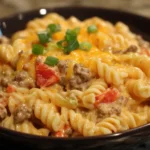 Close-up of Creamy Rotel Pasta with Ground Beef served in a bowl with cheesy sauce and diced tomatoes