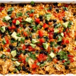 Easy Chicken Burrito Casserole Recipe baked in a dish with chicken, black beans, corn, and avocado