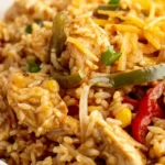 Easy Chicken Fajita Rice Casserole Recipe served in a bowl with peppers, chicken, and melted cheese