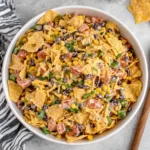 Fresh Frito Corn Salad with vegetables, cheese, and crispy corn chips ready to serve