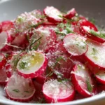 Gordon Ramsay Radish Salad Recipe topped with grated cheese, fresh dill, and thinly sliced radishes