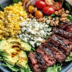 Grilled Balsamic Steak Salad with avocado, corn, gorgonzola, and cherry tomatoes in a bowl