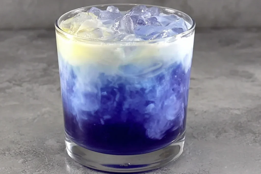Iced Blue Tea Latte Recipe layered with creamy milk and deep blue tea over ice