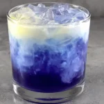 Iced Blue Tea Latte Recipe layered with creamy milk and deep blue tea over ice