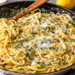 Lemon garlic sauce for pasta tossed with spaghetti, parmesan cheese, and parsley in a pan