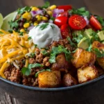 Loaded Potato Taco Bowl Recipe with seasoned ground beef, roasted potatoes, shredded cheese, sour cream, and fresh cilantro