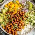 Mango Chickpea Salad bowl with roasted chickpeas, avocado, rice, and fresh mango
