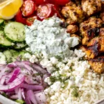 Mediterranean Lemon-Dill Chicken Bowls with grilled chicken, rice, cucumber, feta, and tzatziki