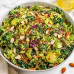 My Favorite Detox Salad with kale, Brussels sprouts, almonds, and fresh vegetables in a vibrant bowl