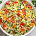 Rainbow Orzo Salad with fresh vegetables, herbs, and lemon dressing in a bowl