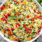 Colorful Rainbow Orzo Salad with basil, cucumber, peppers, and corn