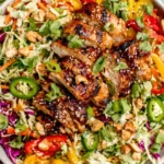 Colorful Sesame Chicken Cabbage Crunch Salad with bell peppers, cashews, and sesame seeds