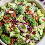 The Best Broccoli Salad with bacon cranberries and almonds in creamy dressing