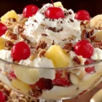 Banana Split Fluff Salad Recipe with pineapple, strawberries, cherries, pecans, and whipped cream topping