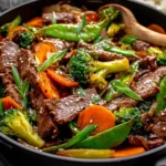 Skillet Beef Stir Fry with Vegetables featuring juicy beef strips, broccoli, carrots, and snow peas